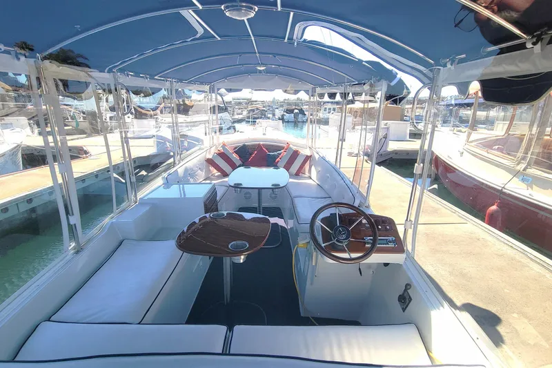 Slide: The Image of Interior view of a 2013 Duffy 21 boat with seating and steering wheel. - 10