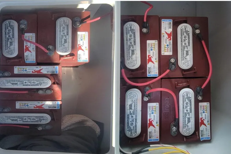 Slide: The Image of Battery compartment of a 2013 Duffy 21 boat, featuring multiple connected batteries. - 11