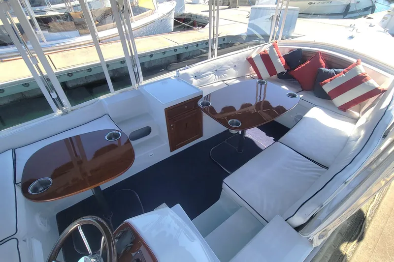 Slide: The Image of Luxurious 2013 Duffy 21 boat interior with plush seating, wooden tables, and nautical-themed cushions. - 9