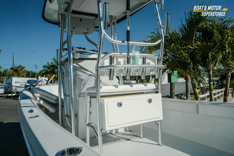 Slide: The Image of 2023 Andros 26 Tarpon boat with sleek design, docked near palm trees. - 10