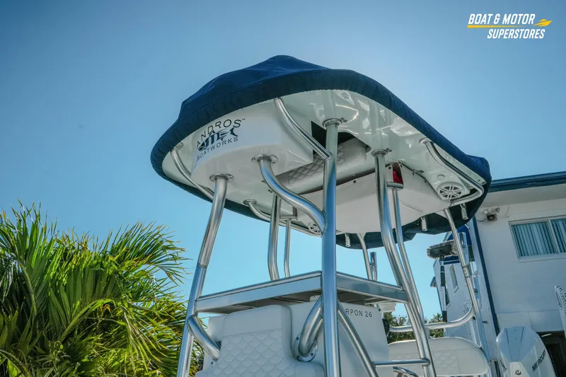 Slide: The Image of 2023 Andros 26 Tarpon boat with T-top, viewed from below, against a clear sky. - 13