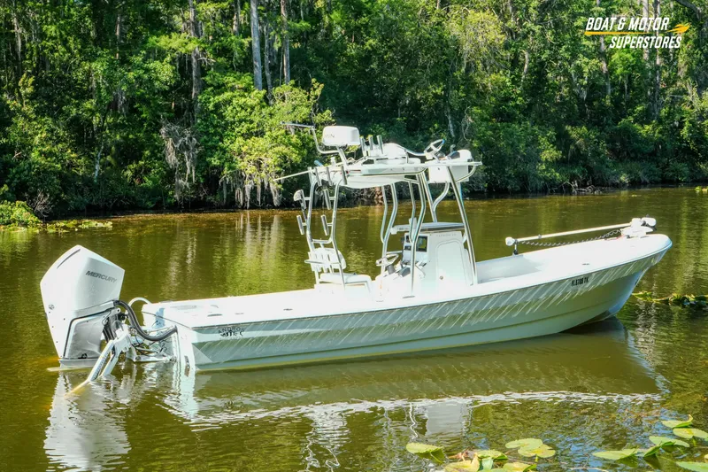 Slide: The Image of 2023 Andros 26 Tarpon boat on a serene river, surrounded by lush greenery. - 19