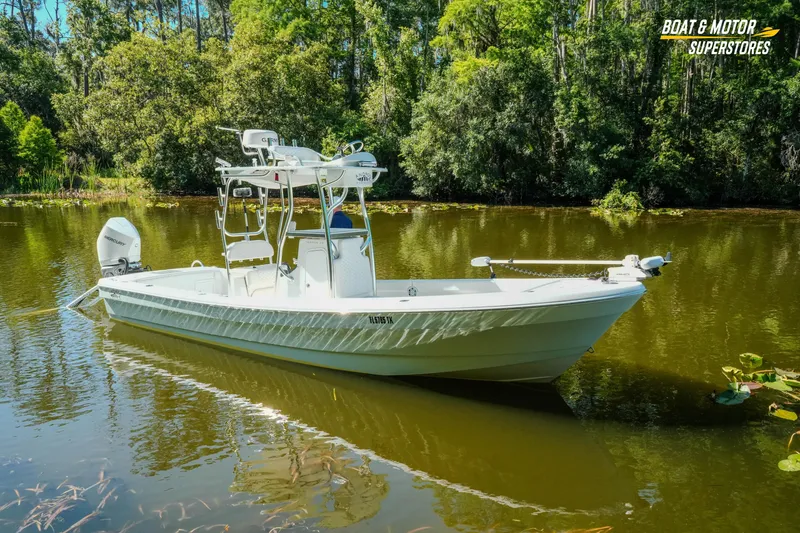Slide: The Image of 2023 Andros 26 Tarpon boat on a serene lake surrounded by lush greenery. - 20