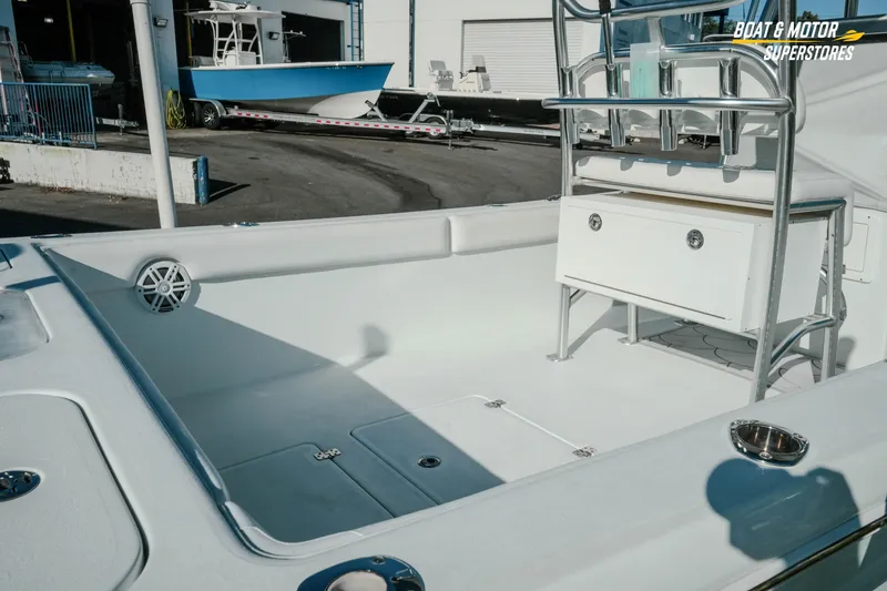 Slide: The Image of 2023 Andros 26 Tarpon boat interior with seating and storage, showcased at a dealership. - 8
