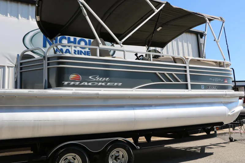 Slide: The Image of 2021 Sun Tracker Party Barge 20 DLX pontoon boat on trailer at dealership. - 13