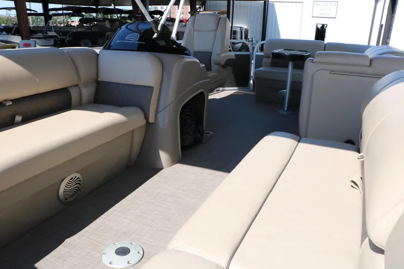 Slide: The Image of 2021 Sun Tracker Party Barge 20 DLX interior with beige seating and spacious layout. - 18