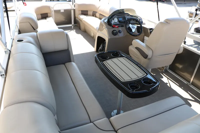 Slide: The Image of 2021 Sun Tracker Party Barge 20 DLX interior with plush seating and modern helm. - 20