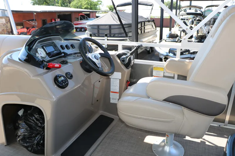 Slide: The Image of 2021 Sun Tracker Party Barge 20 DLX helm with steering wheel and captain's chair. - 29