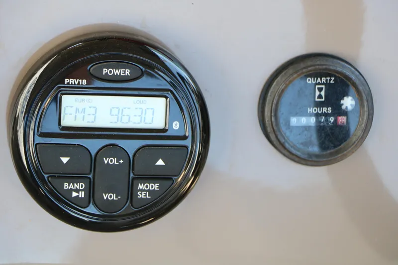 Slide: The Image of 2021 Sun Tracker Party Barge 20 DLX dashboard with radio and hour meter display. - 32