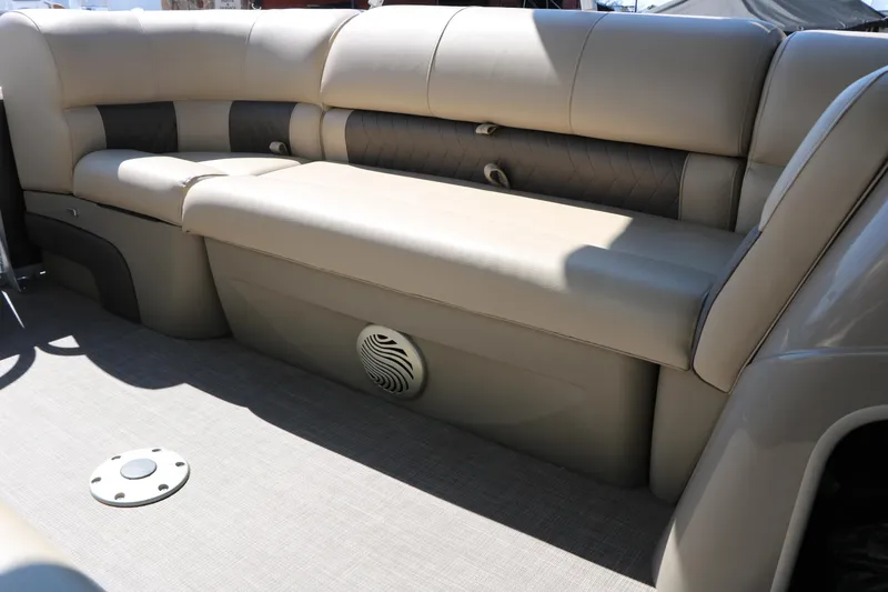 Slide: The Image of 2021 Sun Tracker Party Barge 20 DLX interior seating with beige upholstery and speaker. - 34