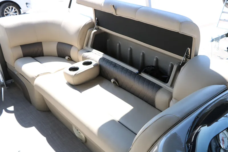 Slide: The Image of 2021 Sun Tracker Party Barge 20 DLX interior seating with storage compartment open. - 37