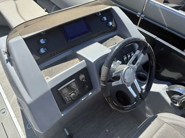 Slide: The Image of 2022 Bennington 23LSR SPS helm with steering wheel and controls. - 16