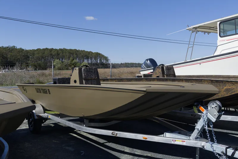 The Image of 2026 G3 Gator Tough 18 CC boat on trailer, outdoors, clear sky. - 1