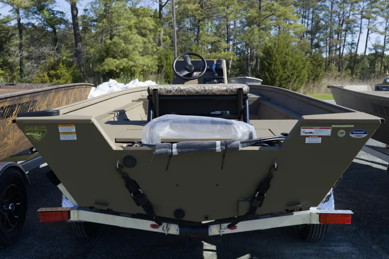 Slide: The Image of 2026 G3 Gator Tough 18 CC boat on trailer, surrounded by trees. - 10
