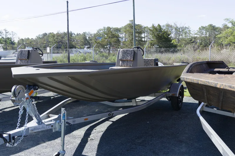 Slide: The Image of 2026 G3 Gator Tough 18 CC boat on trailer, parked outdoors. - 4