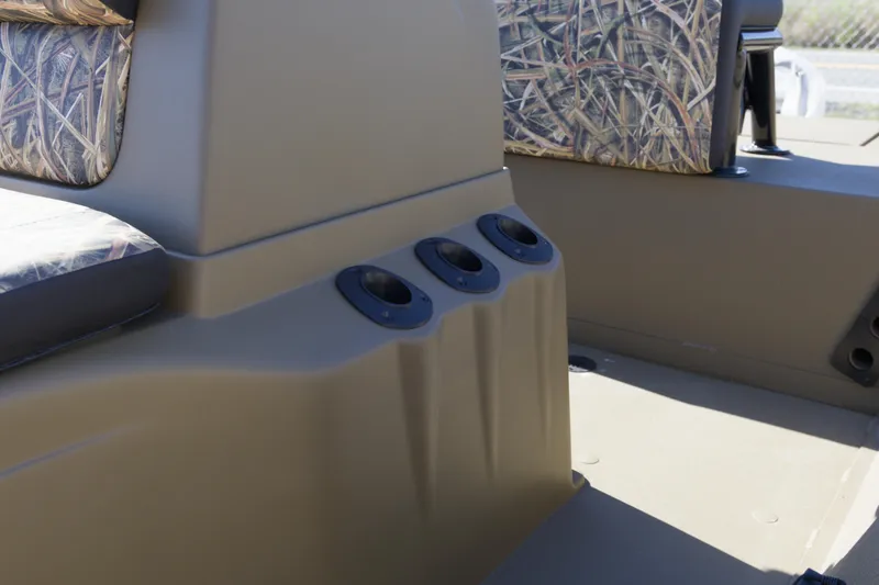 Slide: The Image of 2026 G3 Gator Tough 18 CC boat interior with camo seating and cup holders. - 6