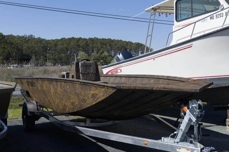 The Image of 2026 G3 Gator Tough 20 CC boat on trailer, camo design, outdoor display. - 1