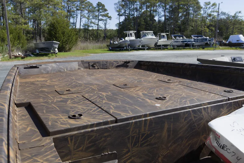 Slide: The Image of 2026 G3 Gator Tough 20 CC boat with camouflage deck, parked outdoors. - 5