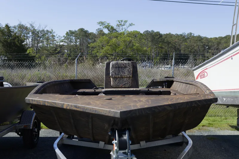 Slide: The Image of 2026 G3 Gator Tough 20 CC boat on trailer, camo design, parked outdoors. - 6