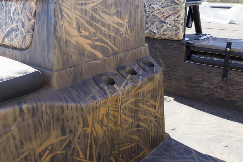 Slide: The Image of 2026 G3 Gator Tough 20 CC boat interior with camouflage design and cup holders. - 7