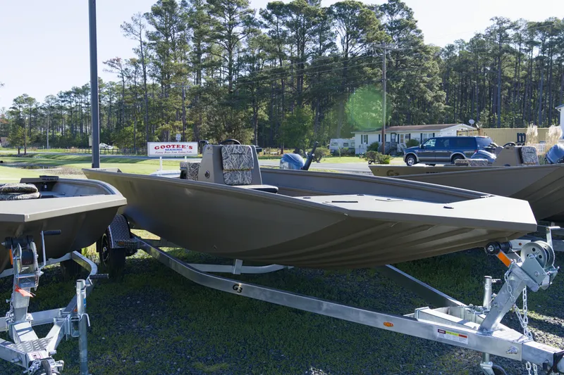 The Image of 2026 G3 Gator Tough 20 CC boat on trailer, parked outdoors near trees. - 1