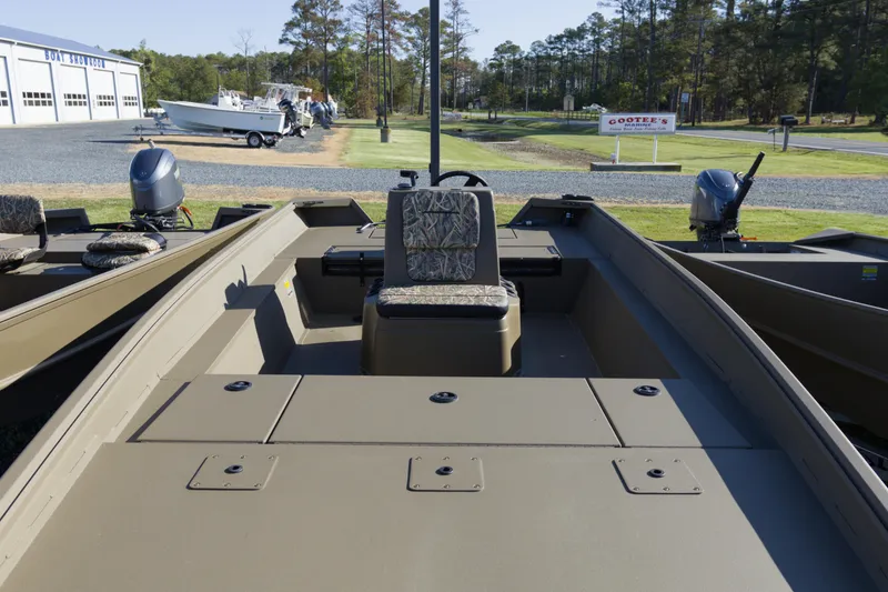 Slide: The Image of 2026 G3 Gator Tough 20 CC boat with camouflage seating, parked outdoors. - 4