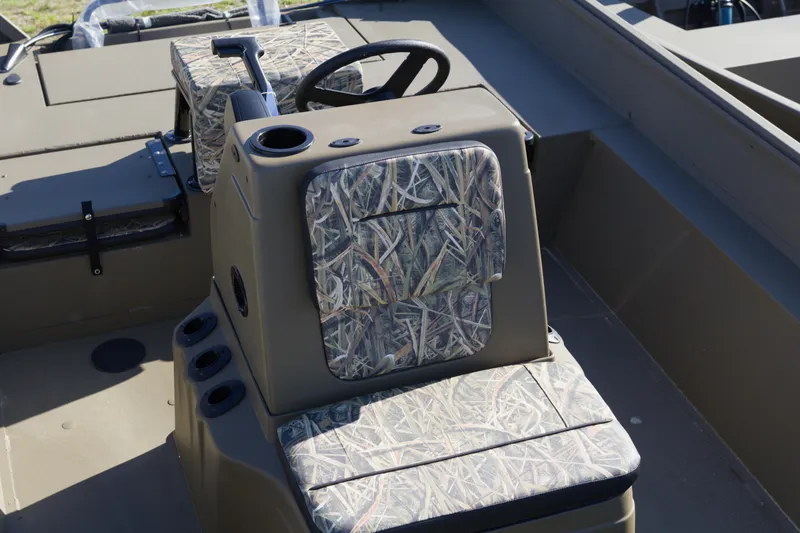 Slide: The Image of 2026 G3 Gator Tough 20 CC boat interior with camouflage seating and steering console. - 7