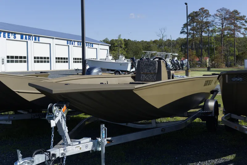 The Image of 2026 G3 Gator Tough 20 CC boat on trailer outside marine showroom. - 1