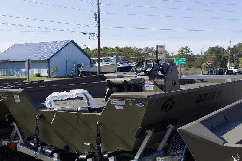 Slide: The Image of 2026 G3 Gator Tough 20 CC boat displayed outdoors on a trailer. - 6