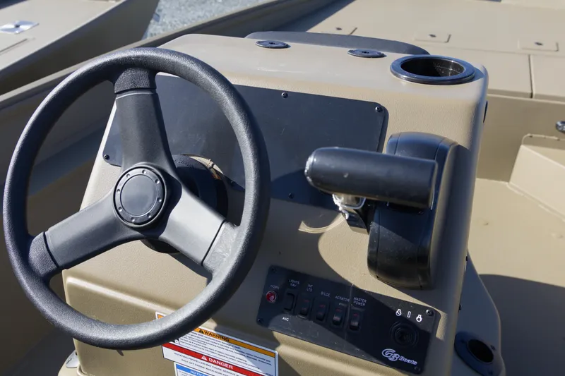 Slide: The Image of Steering console of 2026 G3 Gator Tough 20 CC boat with controls and cup holder. - 9
