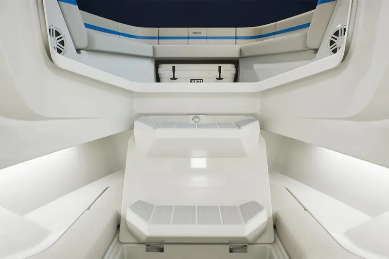 Slide: The Image of Interior view of 2026 Wellcraft 28 T-Top boat, featuring sleek seating and storage. - 10