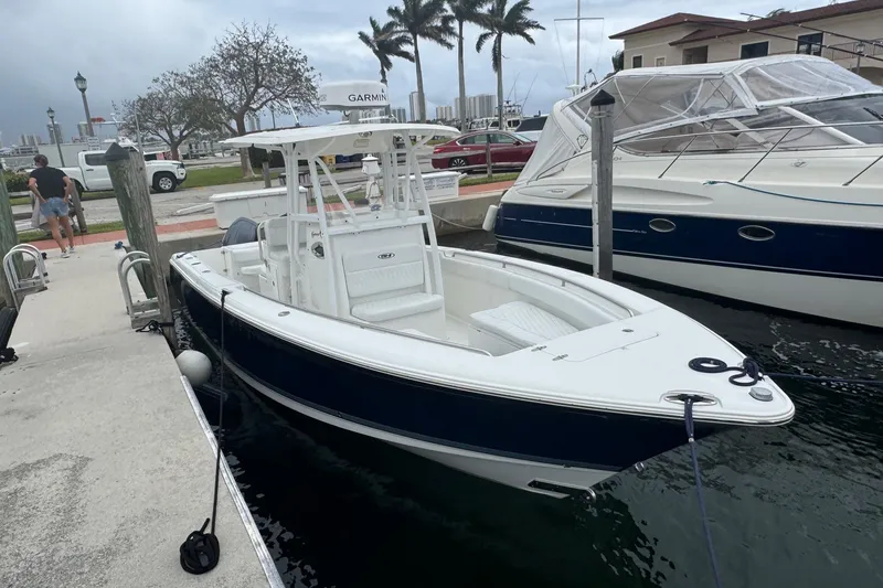 The Image of 2011 Sea Hunt Gamefish 27 boat docked, featuring forward seating and sleek design. - 0
