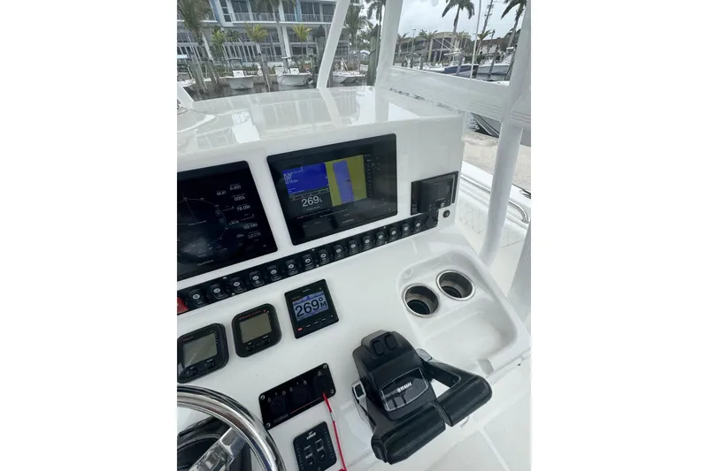 Slide: The Image of 2011 Sea Hunt Gamefish 27 dashboard with navigation screens and controls. - 4