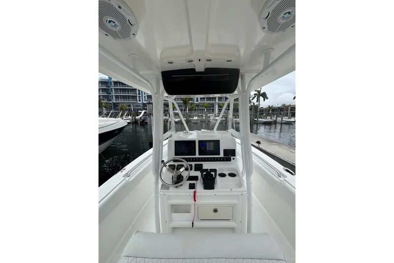 Slide: The Image of 2011 Sea Hunt Gamefish 27 boat interior with steering wheel and navigation system. - 5