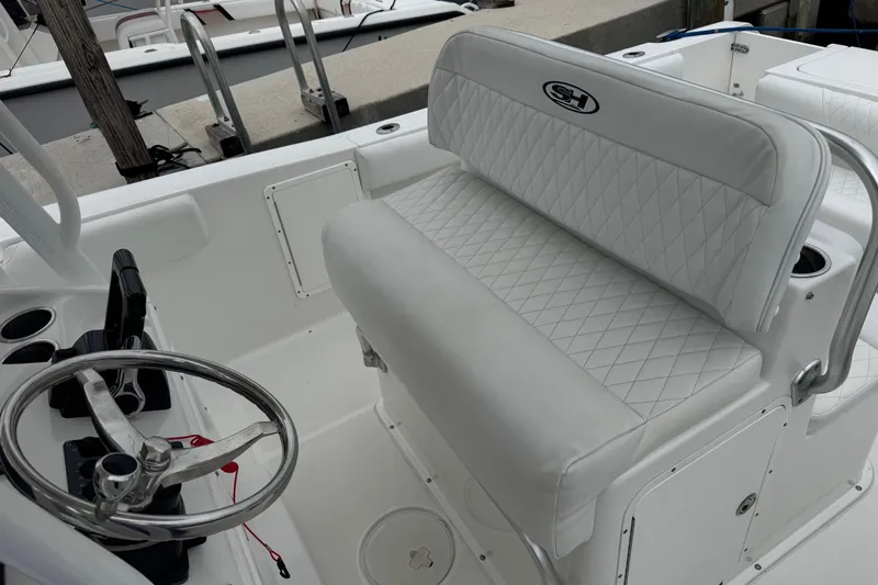 Slide: The Image of 2011 Sea Hunt Gamefish 27 boat interior with steering wheel and cushioned seating. - 6