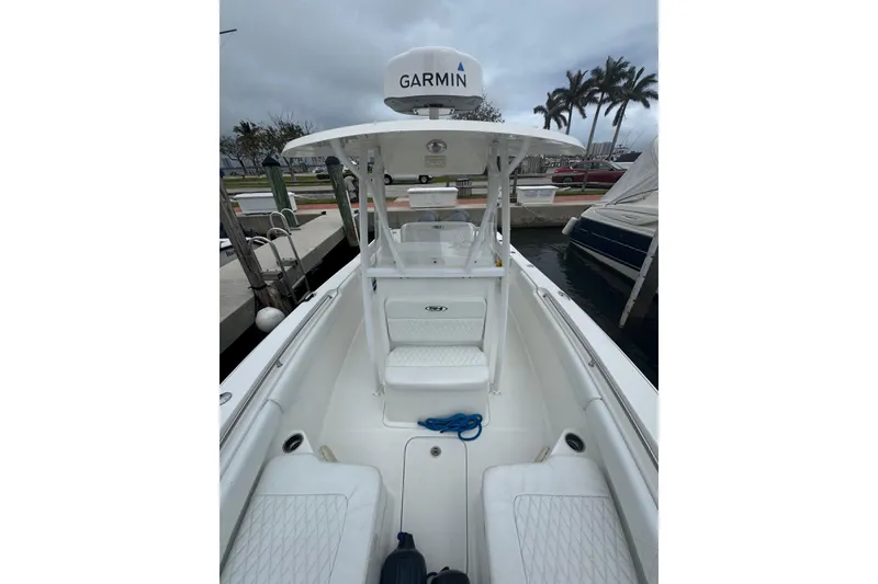 Slide: The Image of 2011 Sea Hunt Gamefish 27 boat with forward seating, docked, featuring Garmin equipment. - 7