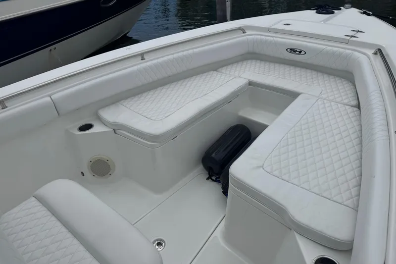 Slide: The Image of 2011 Sea Hunt Gamefish 27 Forward Seating with white cushioned interior and diamond stitching. - 8