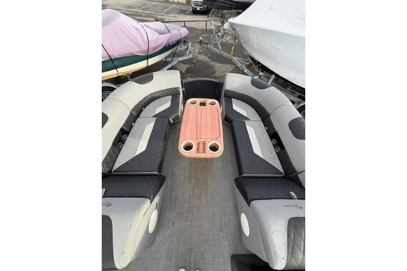Slide: The Image of 2024 Massimo Marine P-22 Limited boat interior with stylish seating and wooden table. - 5