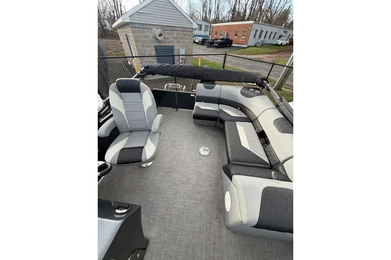 Slide: The Image of 2024 Massimo Marine P-22 Limited pontoon boat interior with gray seating and spacious layout. - 8