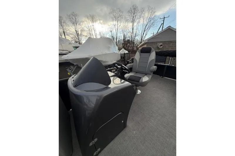 Slide: The Image of 2024 Massimo Marine P-22 Limited boat interior with steering console and captain's chair. - 9