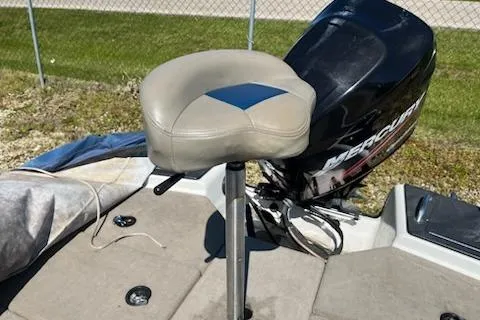 Slide: The Image of 2004 Ranger 210 Reata boat seat and Mercury engine, outdoor setting. - 11