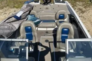 Slide: The Image of 2004 Ranger 210 Reata boat interior with seating and open deck layout. - 12