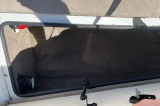 Slide: The Image of Open storage compartment in a 2004 Ranger 210 Reata boat. - 13