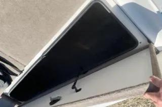 Slide: The Image of Open storage compartment on a 2004 Ranger 210 Reata boat. - 15