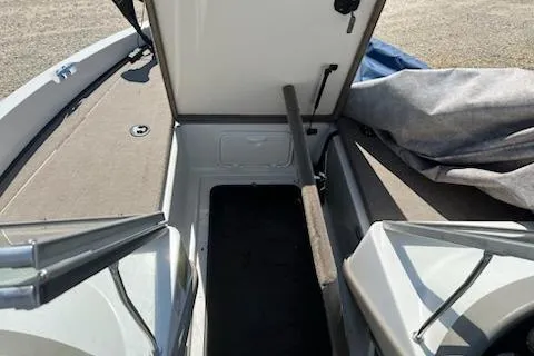 Slide: The Image of Open storage compartment on a 2004 Ranger 210 Reata boat, showing interior space. - 16