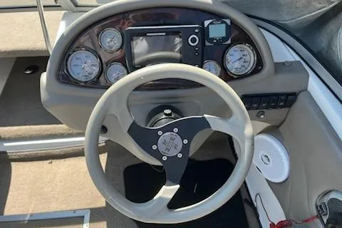 Slide: The Image of Steering wheel and dashboard of 2004 Ranger 210 Reata boat with gauges and controls. - 18
