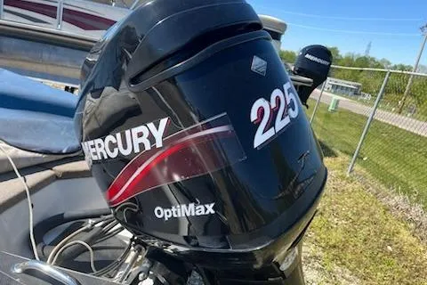 Slide: The Image of 2004 Ranger 210 Reata boat with Mercury OptiMax 225 engine, parked outdoors. - 19