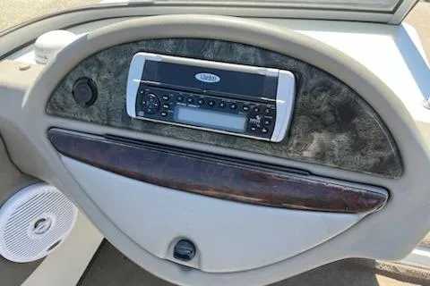 Slide: The Image of Dashboard of a 2004 Ranger 210 Reata boat featuring a stereo system. - 2