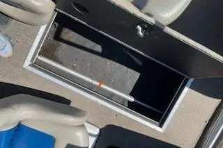 Slide: The Image of Open storage compartment on a 2004 Ranger 210 Reata boat, surrounded by seats. - 3