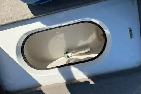 Slide: The Image of 2004 Ranger 210 Reata boat compartment with white interior and black trim. - 6
